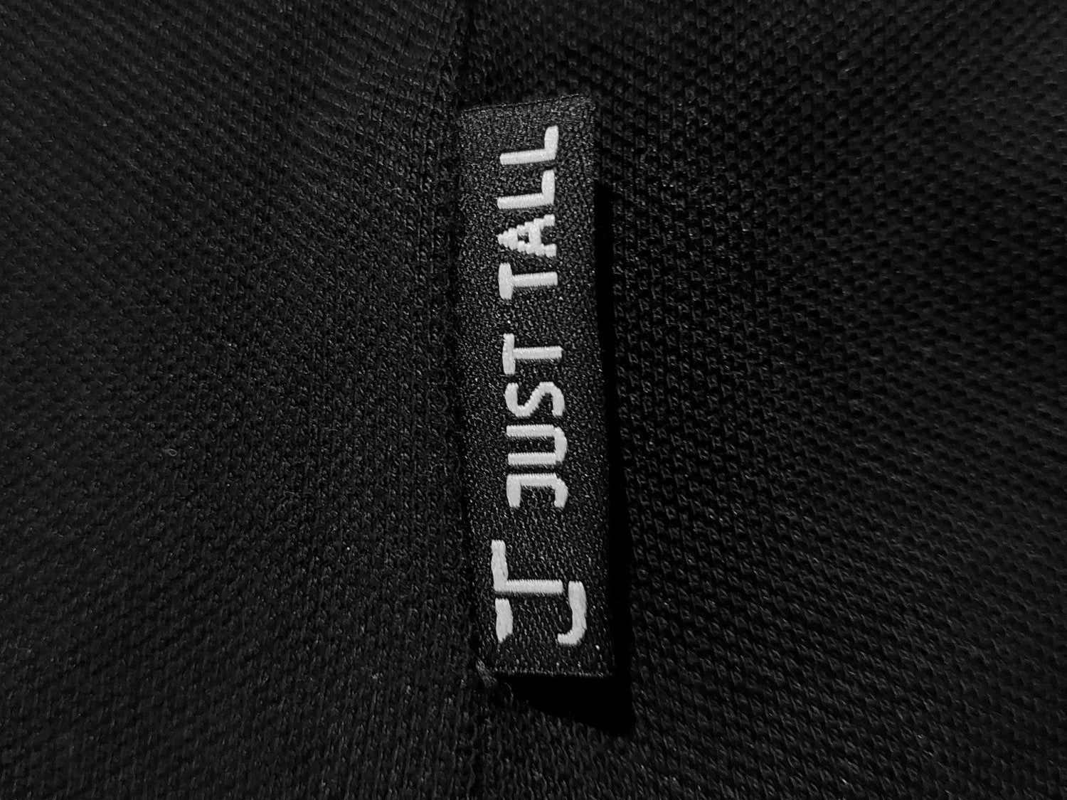 Close up of the Just Tall flag label just above the polo side vents.