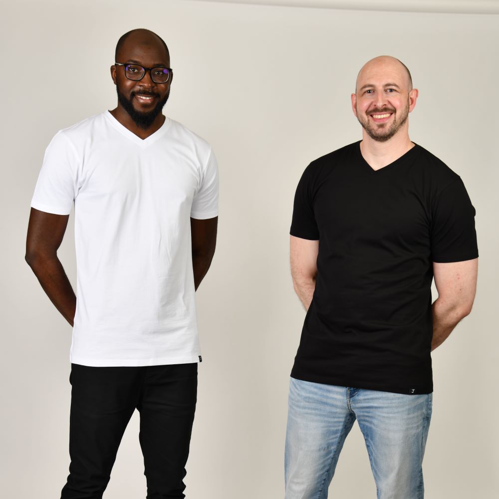 Two tall skinny guys wearing tall v-neck t-shirts.