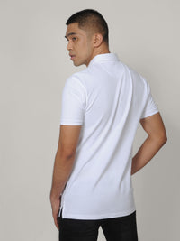 Thumbnail for A shot from behind of a tall skinny guy wearing a tall white pique polo shirt.