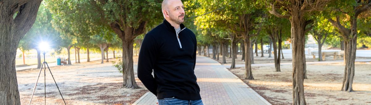 A tall slim guy wearing an XL tall slim quarter zip sweatshirt.
