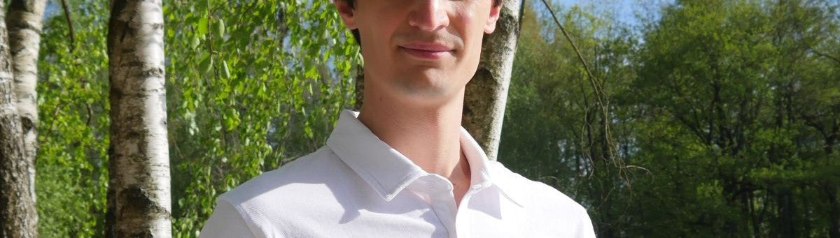 A tall slim guy wearing a Just Tall medium tall polo shirt.
