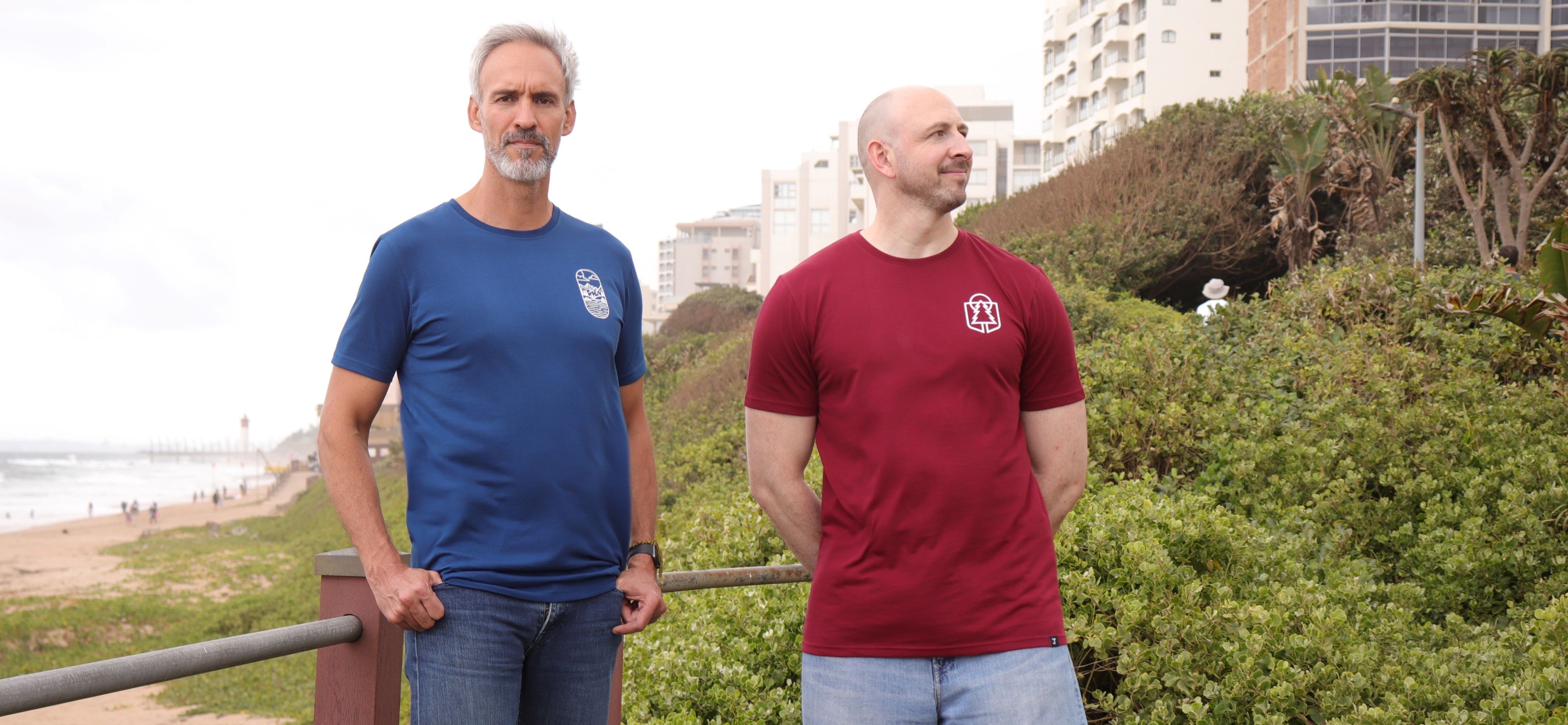 Two tall skinny guys wearing a navy large tall graphic t-shirt and a maroon XL tall graphic t-shirt.