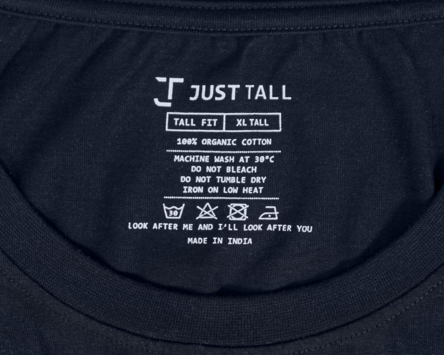 A close up of a printed Just Tall neck label detailing the size and care instructions.