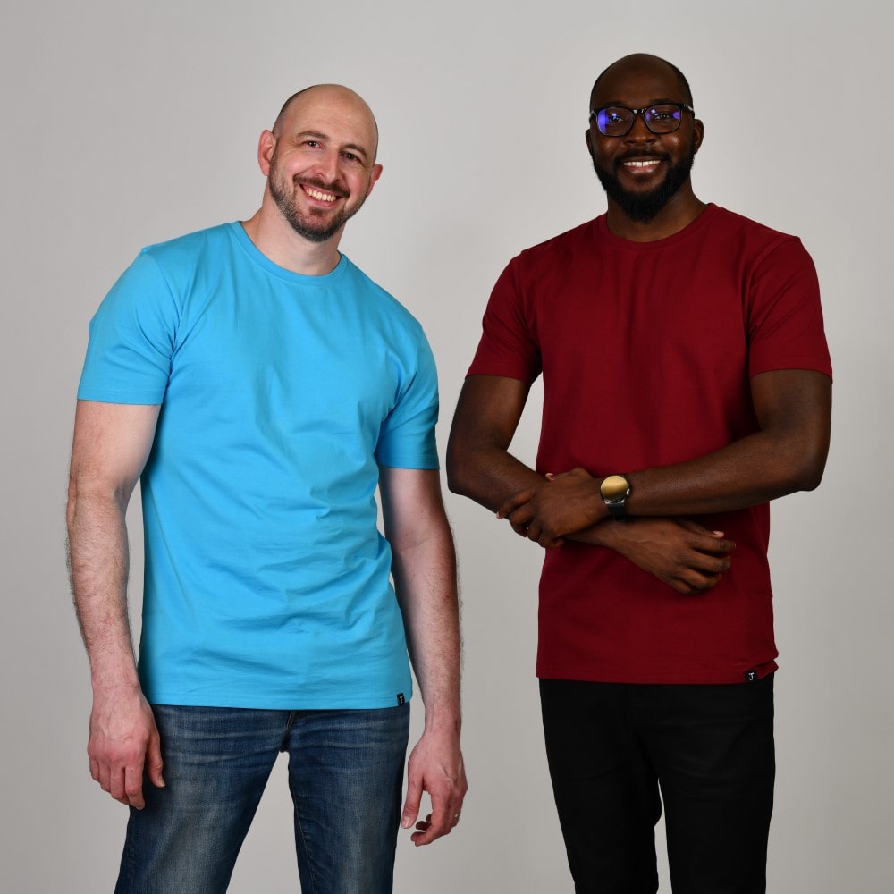 Two tall slim guys wearing tall slim crew neck t-shirts in cyan and cabernet.