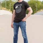 A head to toe shot of a tall skinny guy wearing a tall black graphic t-shirt.