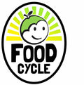 Logo of Food Cycle with a smiling face and green apple on a white background