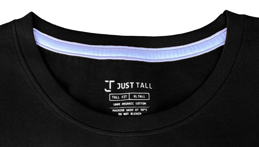 A close-up of a Just Tall t-shirt neckline showing a tagless, screen printed neck label.