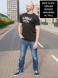 Thumbnail for A head to toe shot of a tall skinny guy wearing a tall graphic bodybuilding t-shirt.