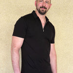 Tall slim man wearing an XL tall black zip polo shirt.