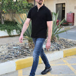 A tall slim man wearing an XL tall black zip polo shirt.