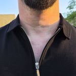 A close up of the self fabric collar of an XL tall black zip polo.