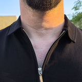 A close up of the self fabric collar of an XL tall black zip polo.
