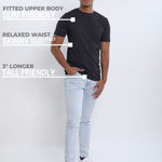 A head to toe shot of a tall and slim guy wearing a charcoal medium tall t-shirt.