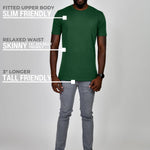 A head to toe shot of a tall athletic guy wearing a dark green large tall t-shirt.