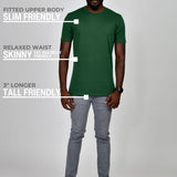 A head to toe shot of a tall athletic guy wearing a dark green large tall t-shirt.