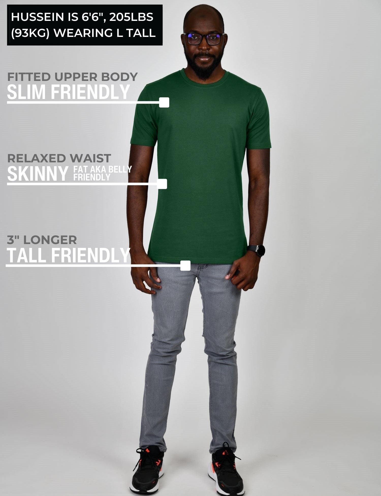 A head to toe shot of a tall athletic guy wearing a dark green large tall t-shirt.