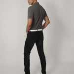 A shot from behind of a tall skinny guy wearing a tall grey pique polo shirt.