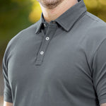 A close up of a stay-flat dark slate tall polo collar.