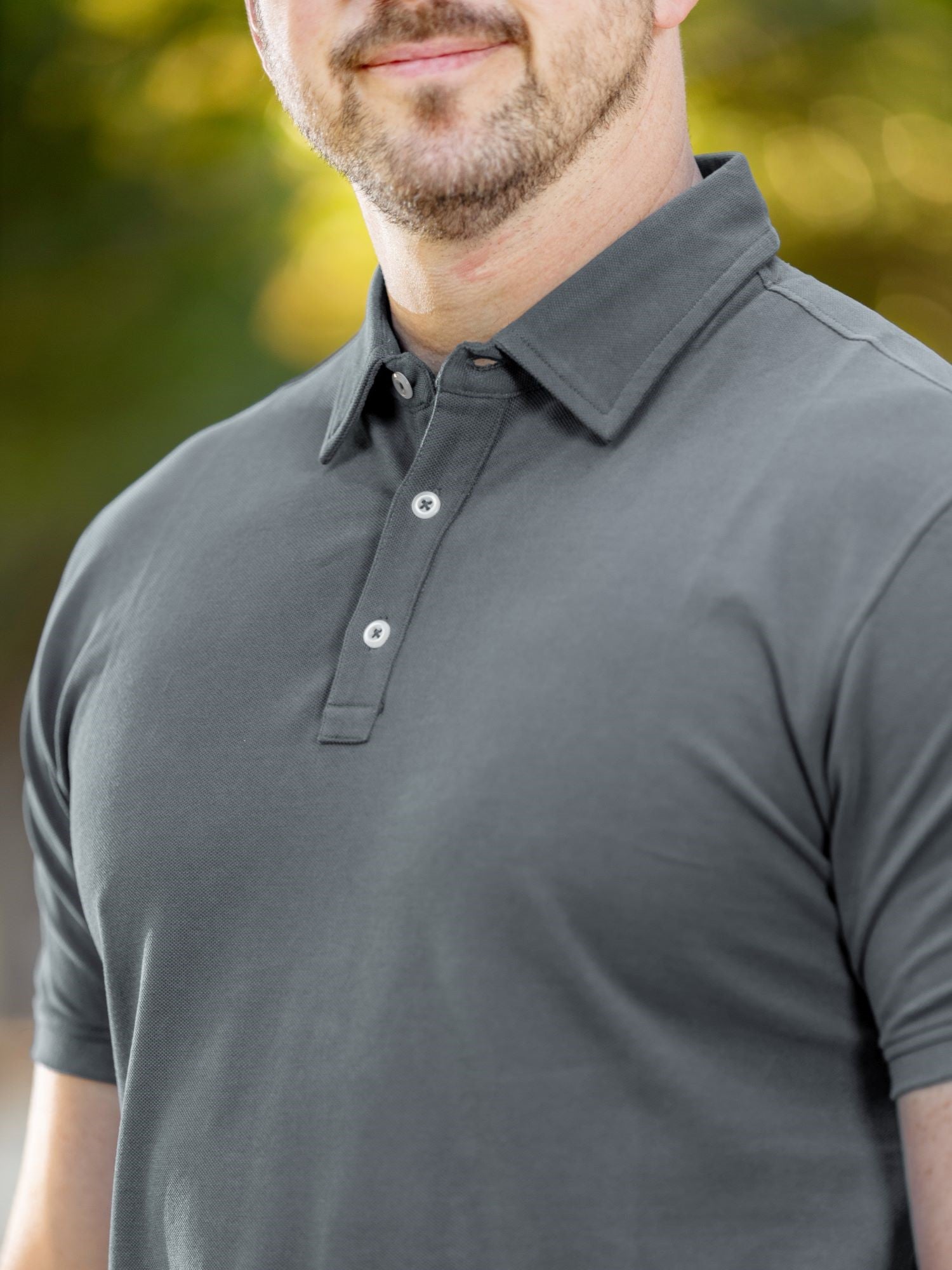 A close up of a stay-flat dark slate tall polo collar.