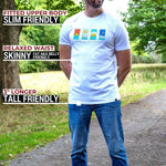 A tall man wearing a white graphic t-shirt and blue jeans stands on a dirt path outdoors with trees in the background. Text overlays on the left describe the t-shirt's slim fit and extra long length on a 6'5" model.