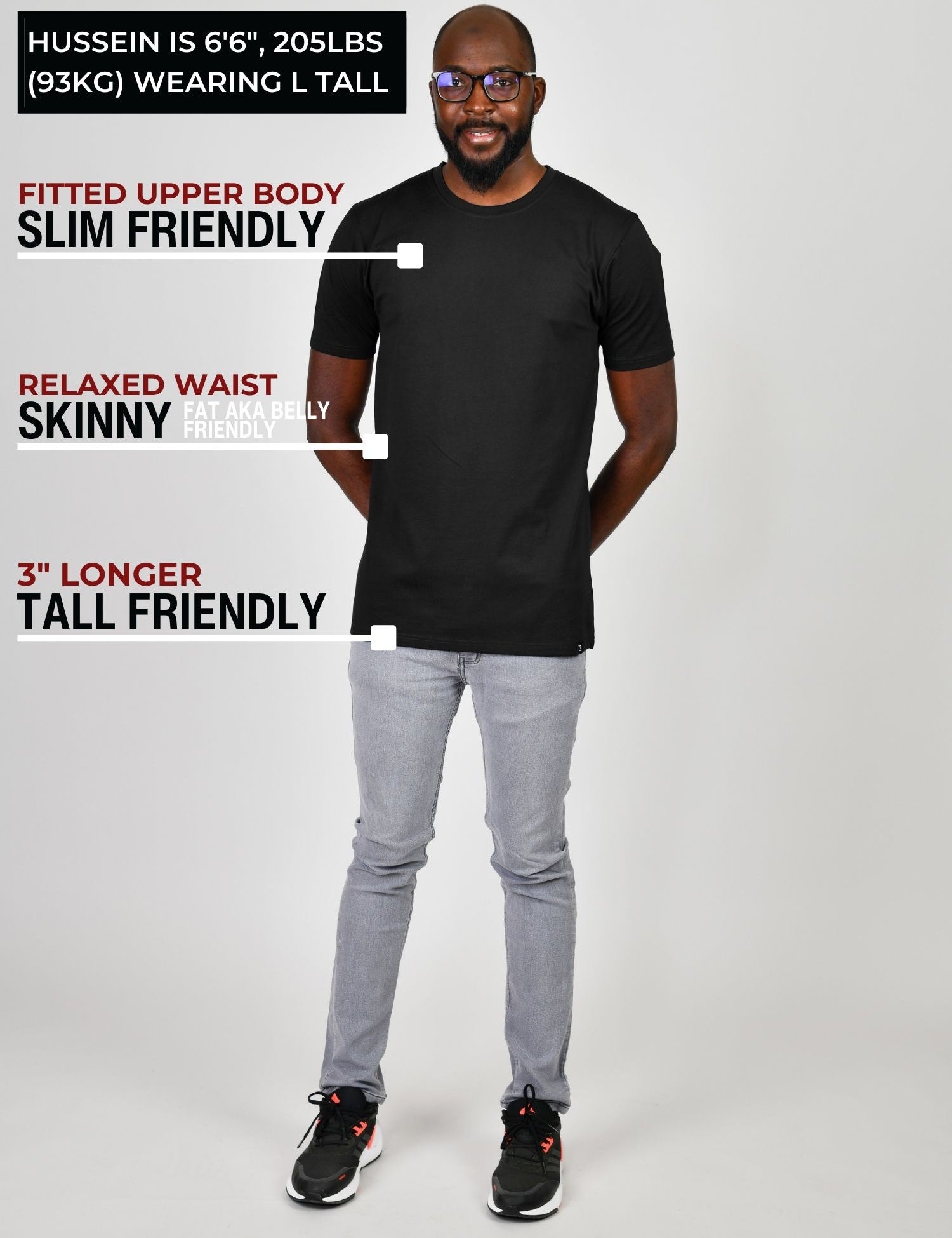 A head to toe shot of a tall slim guy wearing a large tall heavyweight black t-shirt.