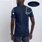 A shot from behind of a tall slim man wearing a large tall heavyweight midnight blue t-shirt.