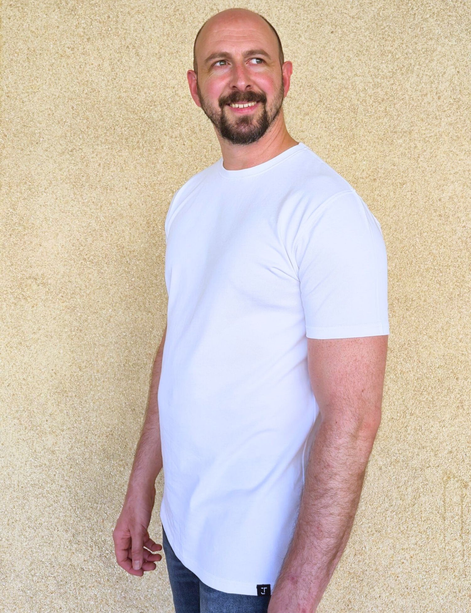 A tall slim man wearing an XL tall heavyweight white t-shirt.