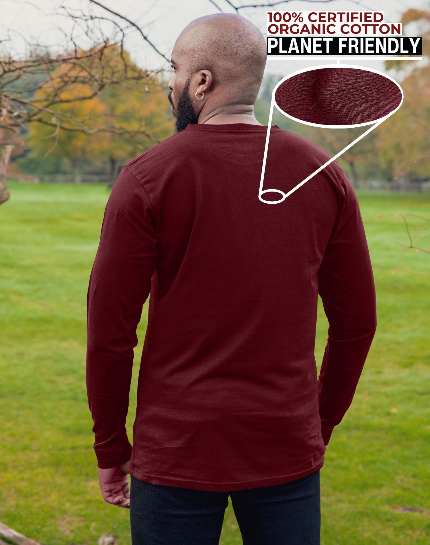 A shot from behind of a tall athletic guy wearing an XL tall maroon long sleeve t-shirt, standing in a park.