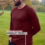 An upper body shot of a tall athletic guy wearing an XL tall maroon long sleeve t-shirt, standing in a park and looking to the right side.