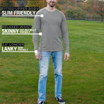 A head to toe shot of a tall athletic guy in a park wearing a light grey long sleeve tall t-shirt.