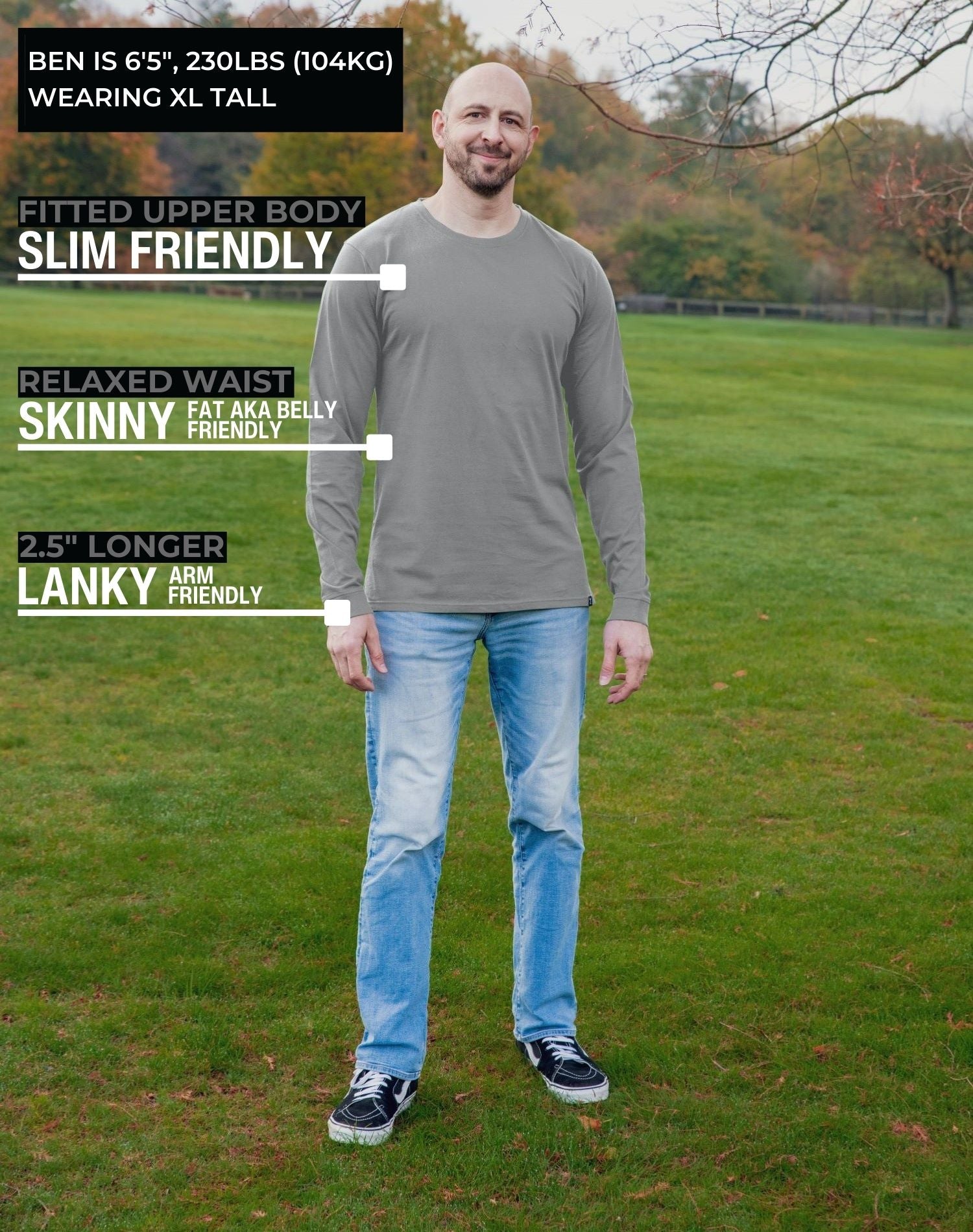 A head to toe shot of a tall athletic guy in a park wearing a light grey long sleeve tall t-shirt.