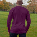 A shot from behind of a tall athletic guy wearing a long sleeve dark purple tall t-shirt.