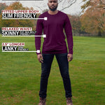 A head to toe shot of a tall athletic guy in a park wearing a dark purple long sleeve tall t-shirt.