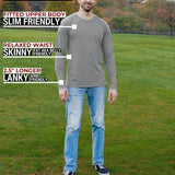 A head to toe shot of a tall athletic guy in a park wearing a light grey long sleeve tall t-shirt.