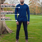 A head to toe shot of a tall athletic guy in a park wearing a navy long sleeve tall t-shirt.