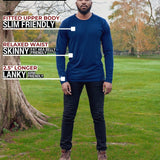 A head to toe shot of a tall athletic guy in a park wearing a navy long sleeve tall t-shirt.