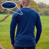A shot from behind of a tall slim guy in a park wearing an extra long sleeve long sleeve tall t-shirt in navy.