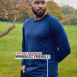 An upper body shot of a tall athletic guy standing in a park wearing a navy extra long tall long sleeve t-shirt and showing  the Just Tall minimalist monogram logo.
