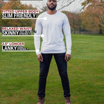 A head to toe shot of a tall athletic guy in a park wearing a white long sleeve tall t-shirt.