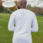 A shot from behind of a tall slim guy in a park wearing an extra long sleeve long sleeve tall t-shirt in white.
