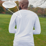 A shot from behind of a tall slim guy in a park wearing an extra long sleeve long sleeve tall t-shirt in white.