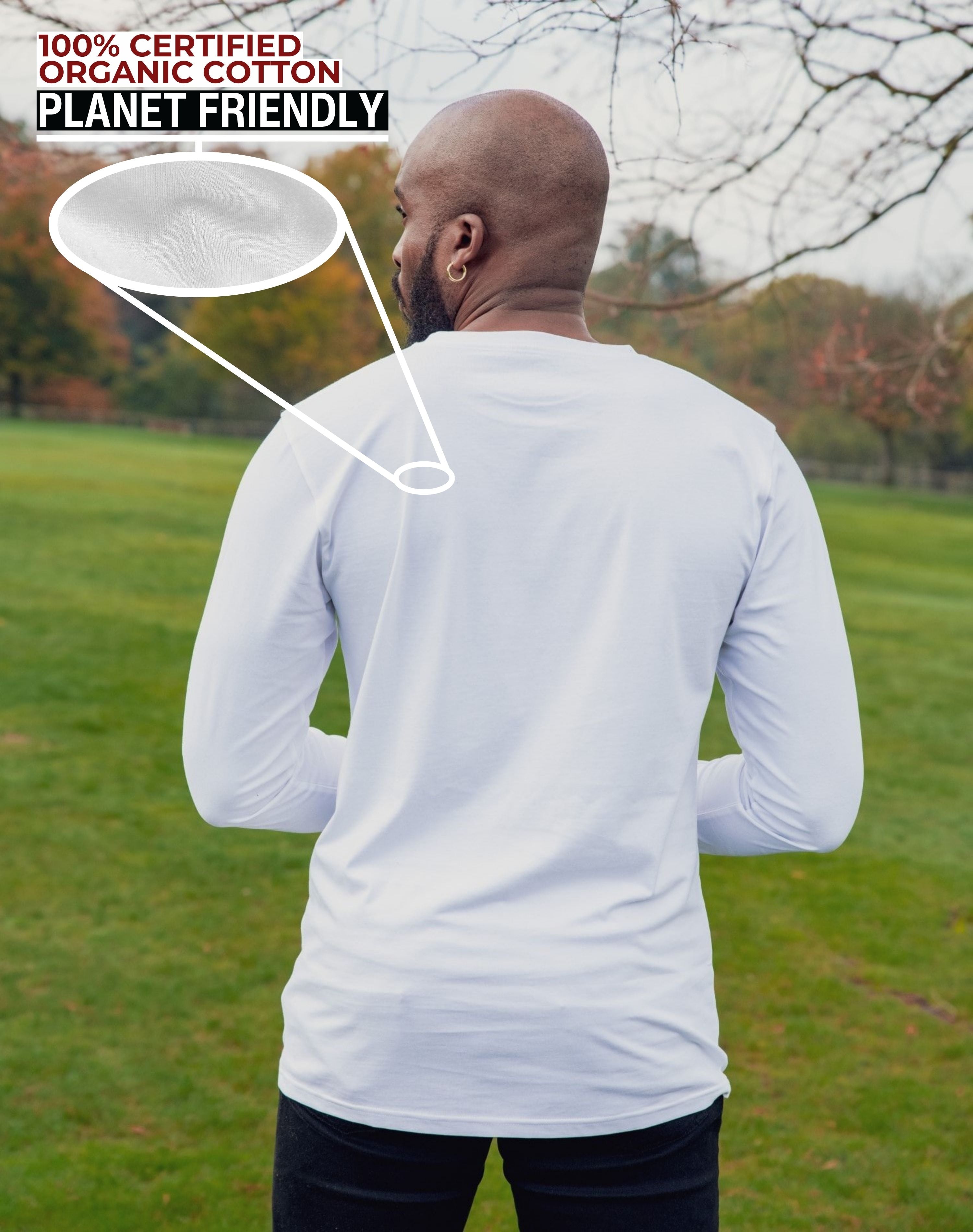 A shot from behind of a tall slim guy in a park wearing an extra long sleeve long sleeve tall t-shirt in white.