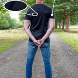 A tall man standing on a park path viewed from behind, wearing a black fitted short-sleeve t-shirt and blue jeans. Text overlays highlight the product features: '100% Mercerised Organic Cotton Planet Friendly' with a fabric swatch circle, and 'Fitted Sleeves Skinny Arm Fit' with a pointer to the sleeve.