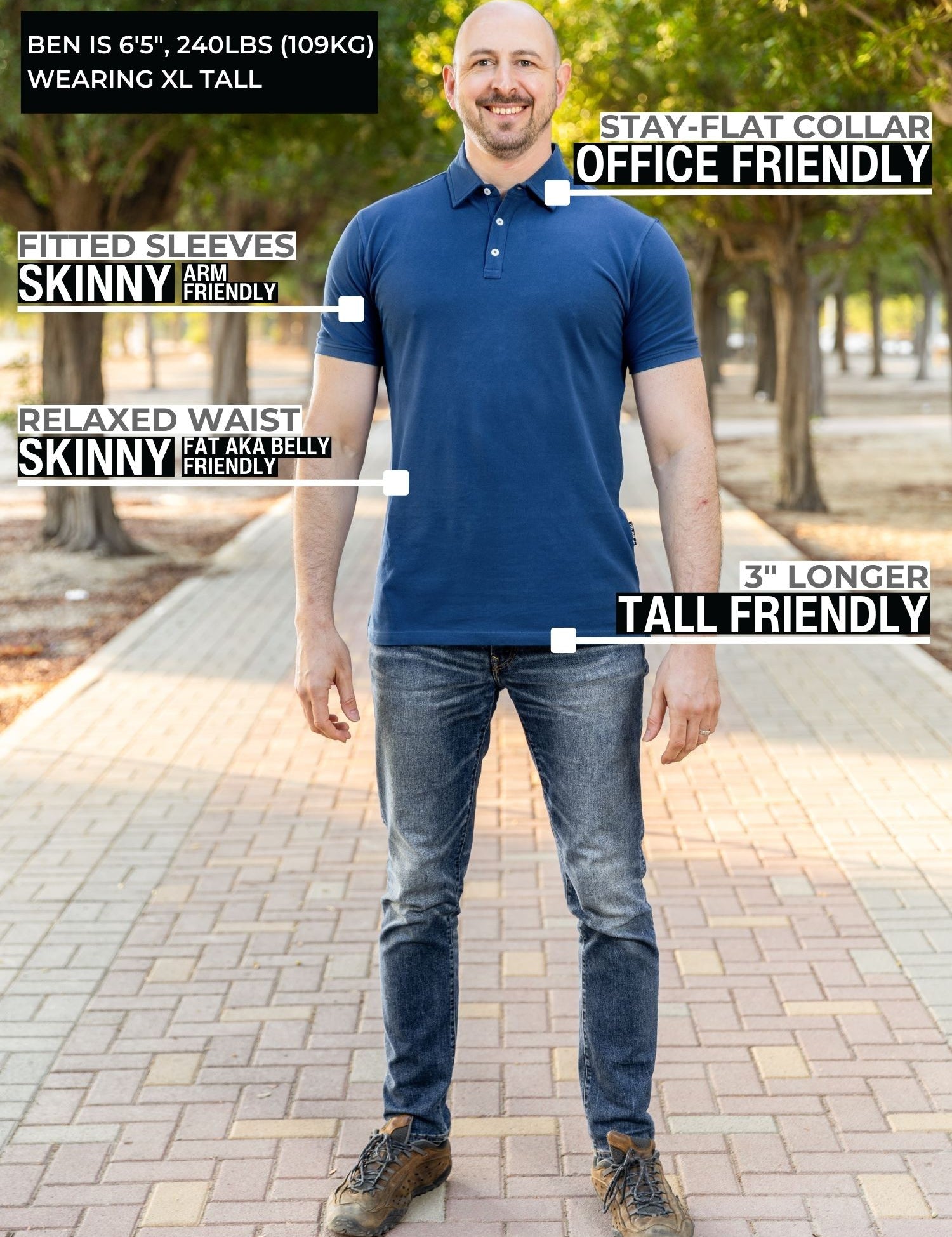 A head to toe shot of a tall athletic man in a park wearing a navy XL tall polo shirt and smiling.