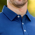 A close up of a stay-flat navy tall polo collar.