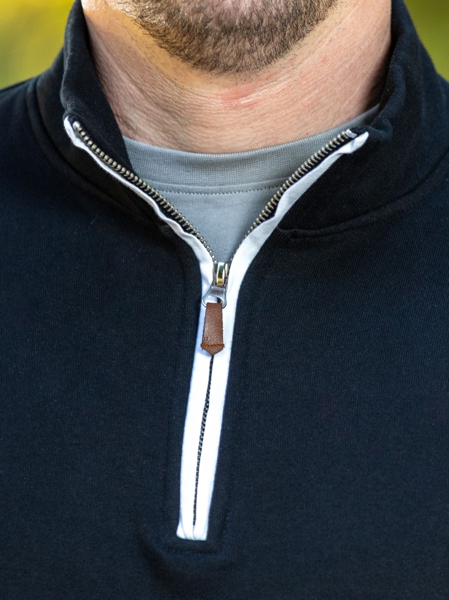 A close-up of the quarter zip collar and the durable metal zipper.