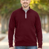 A tall and slim man standing on a path in  a park. The smiling model is wearing a maroon quarter zip sweatshirt. The tall maroon quarter zip sweatshirt features 2.5" longer sleeves, 100% organic french terry cotton, and is soft & comfy. It's  ideal for tall slim men 6'2"+.