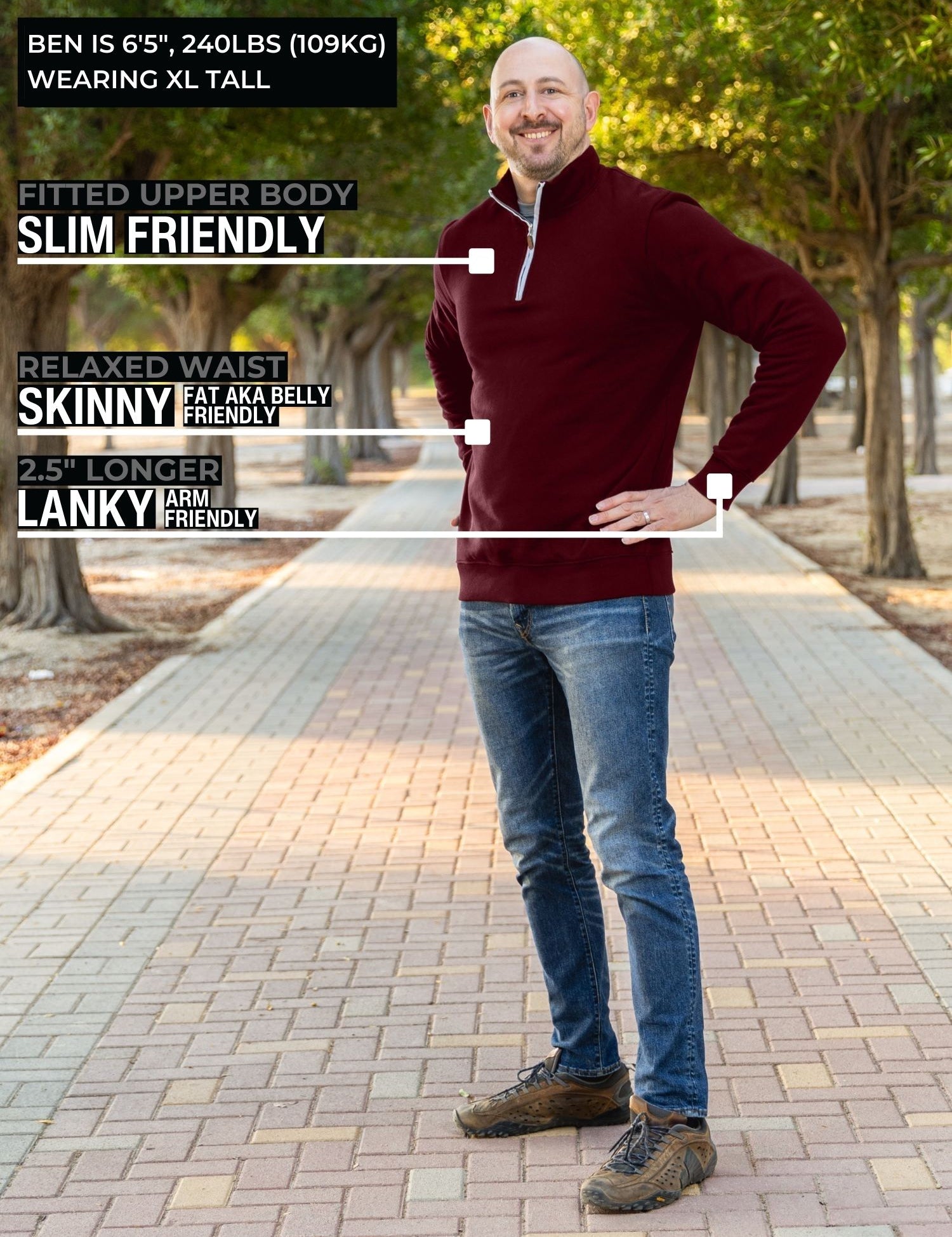 A head to toe shot of a tall slim guy in a park wearing an XL tall extra long maroon quarter zip sweatshirt.