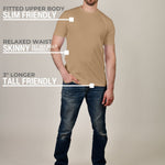 A head to toe shot of a tall athletic guy wearing a tan XL tall t-shirt.