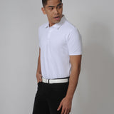 A tall slim guy in a studio and wearing a white M tall polo shirt.